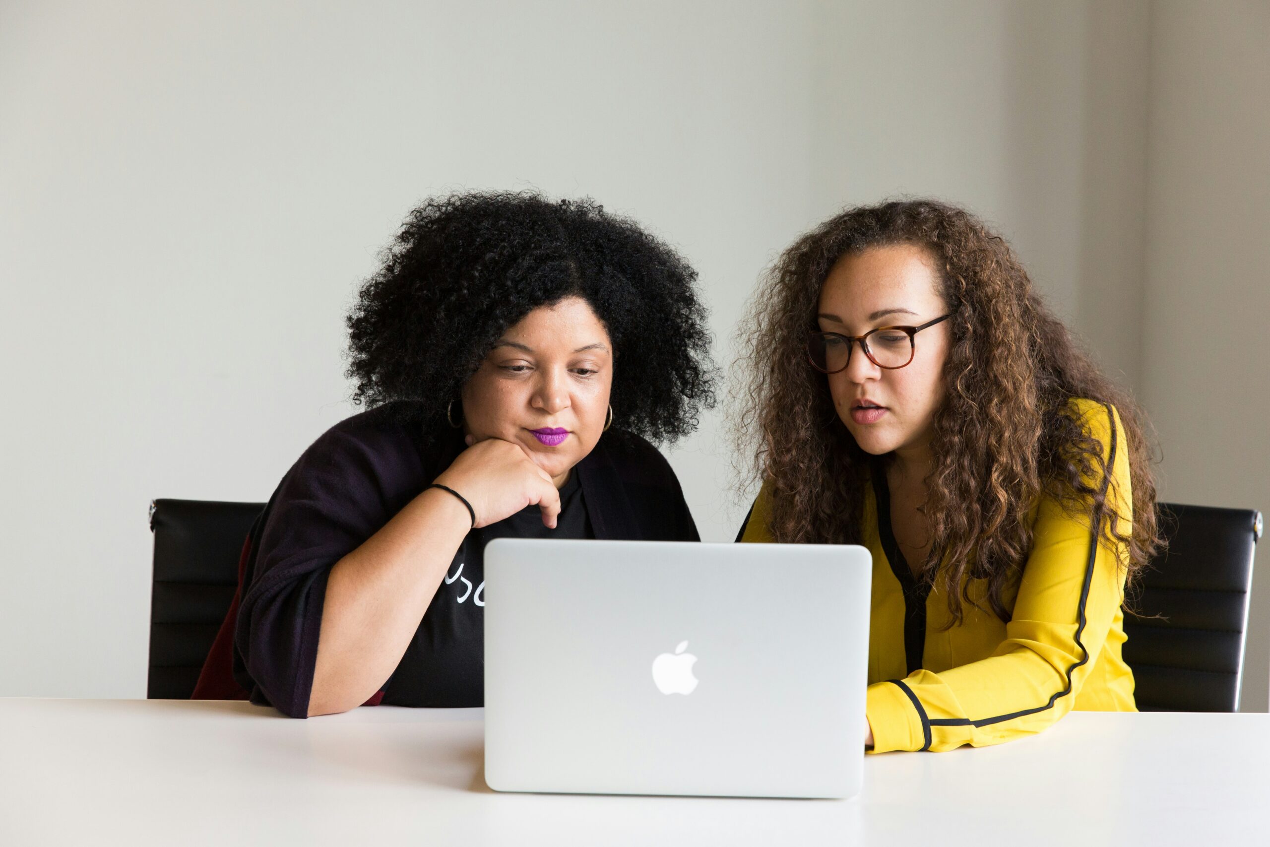 Two women looking at pr opportunities on a computer