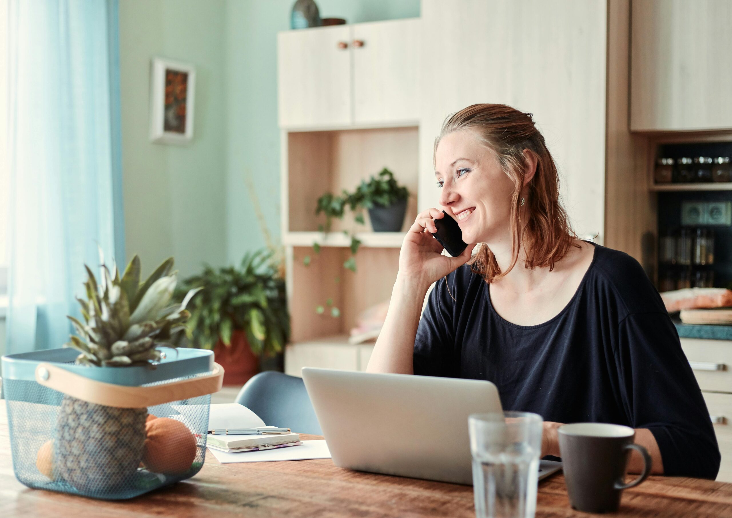 woman at her desk talking on a phone